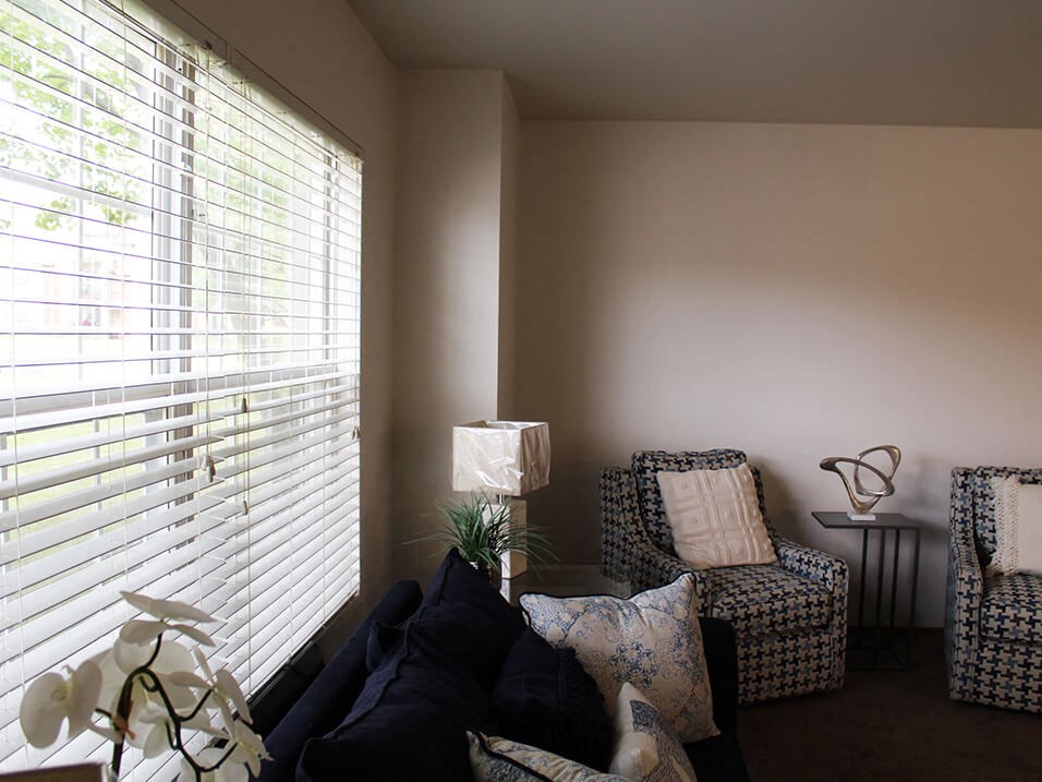 a living room with two chairs and a couch