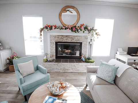 a living room with a fireplace and two couches and a coffee table