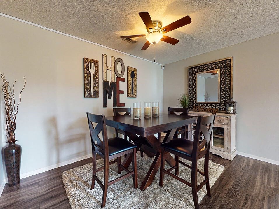 a dining room with a table and chairs