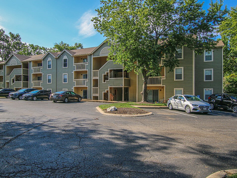 a parking lot in front of an apartment complex