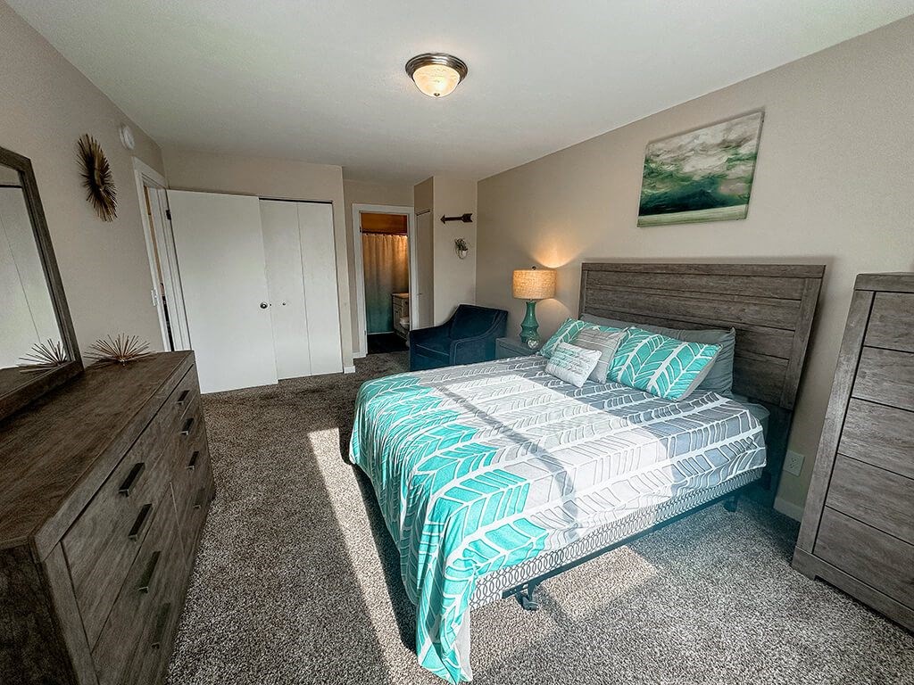 a bedroom with a bed and a dresser