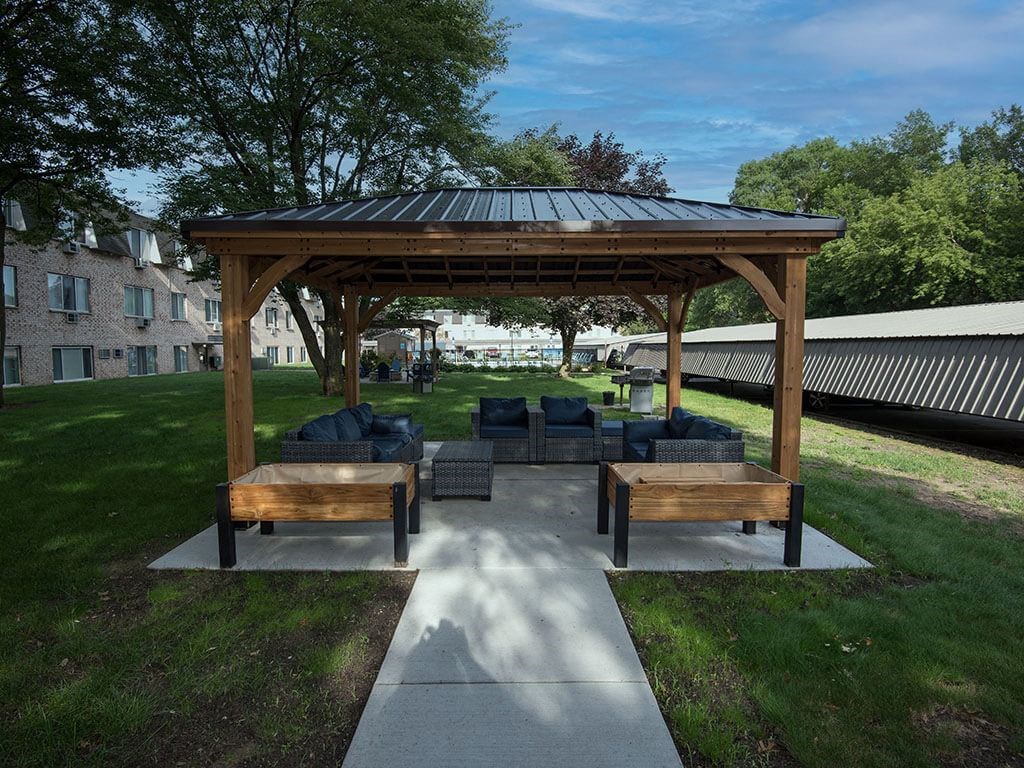 a pavilion with a couch and tables on a patio