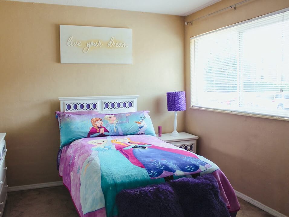 a bedroom with a bed and a lamp