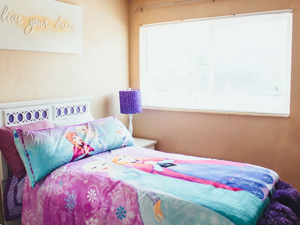 a bedroom with a bed and a window