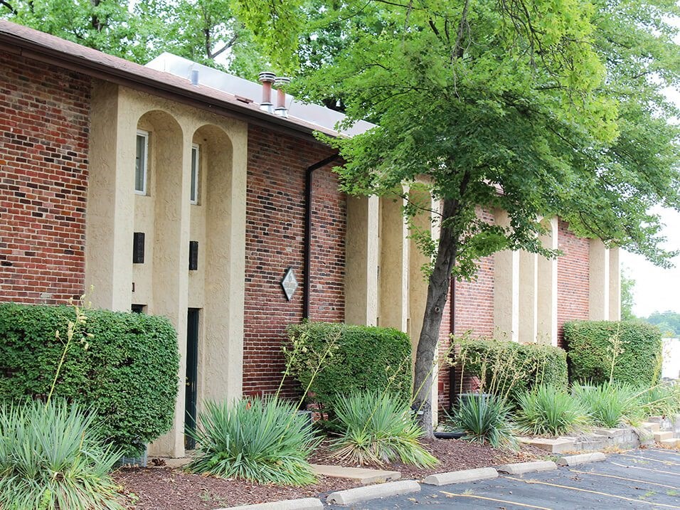 apartment building with a tree in front of it