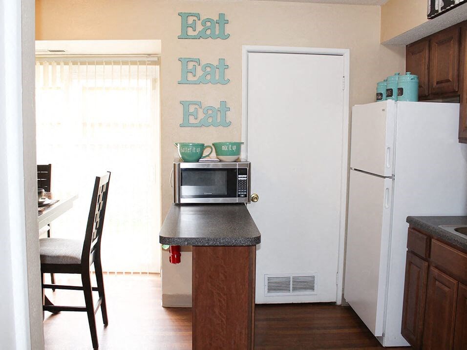 a open kitchen with a refrigerator