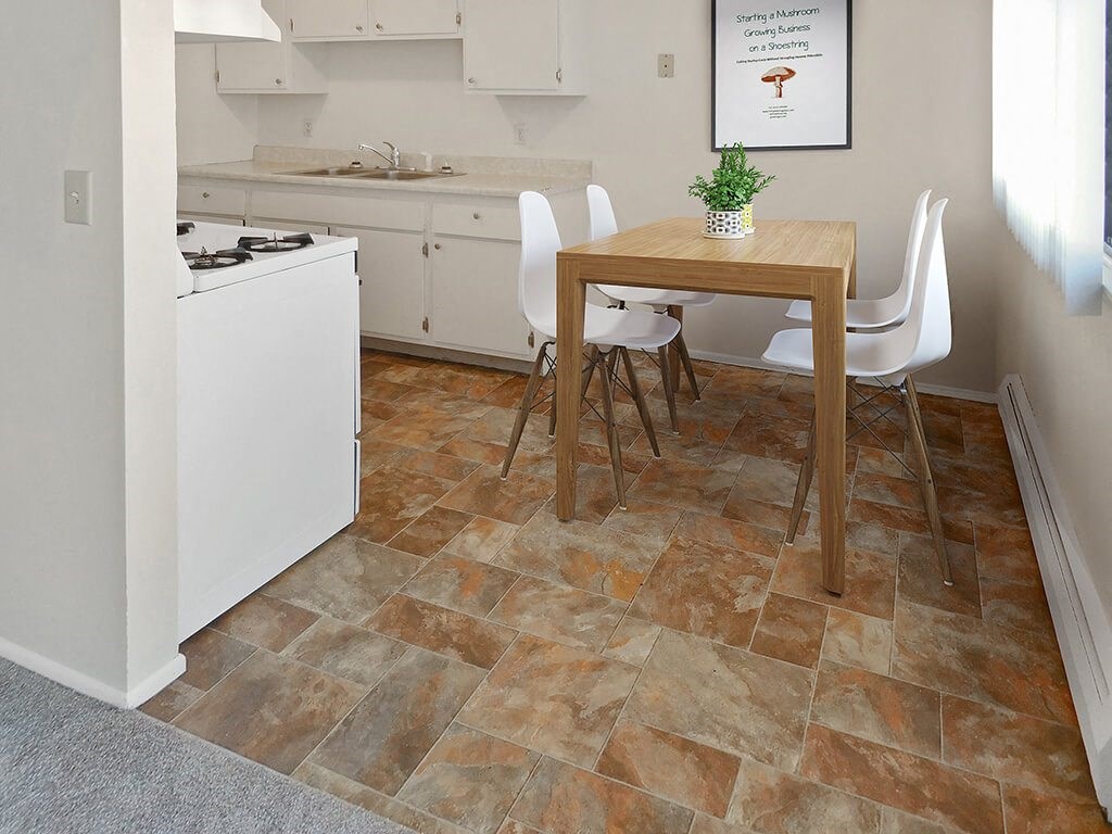 a kitchen with a table and chairs and a stove