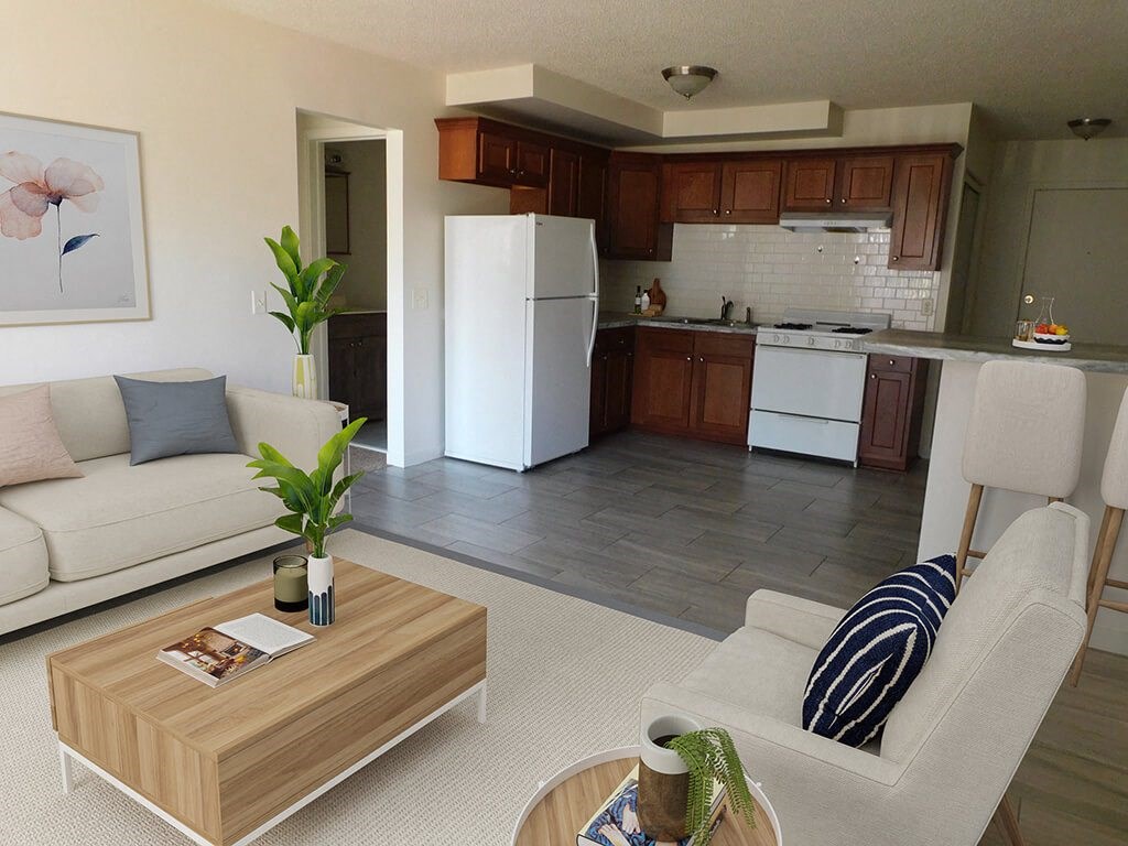 carpeted living room with attached kitchen in open layout