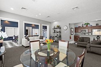 a living room and dining room with a glass table