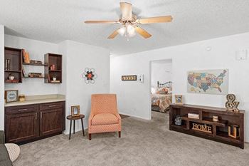 a living room with a ceiling fan and a couch