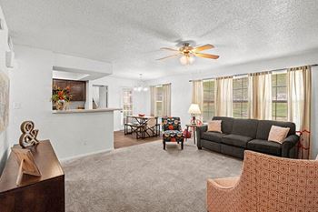 a living room with a couch and a ceiling fan