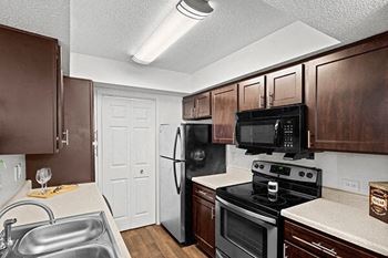 a kitchen with a stove refrigerator and a sink