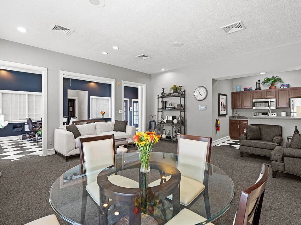 a clubhouse with a glass table and chairs
