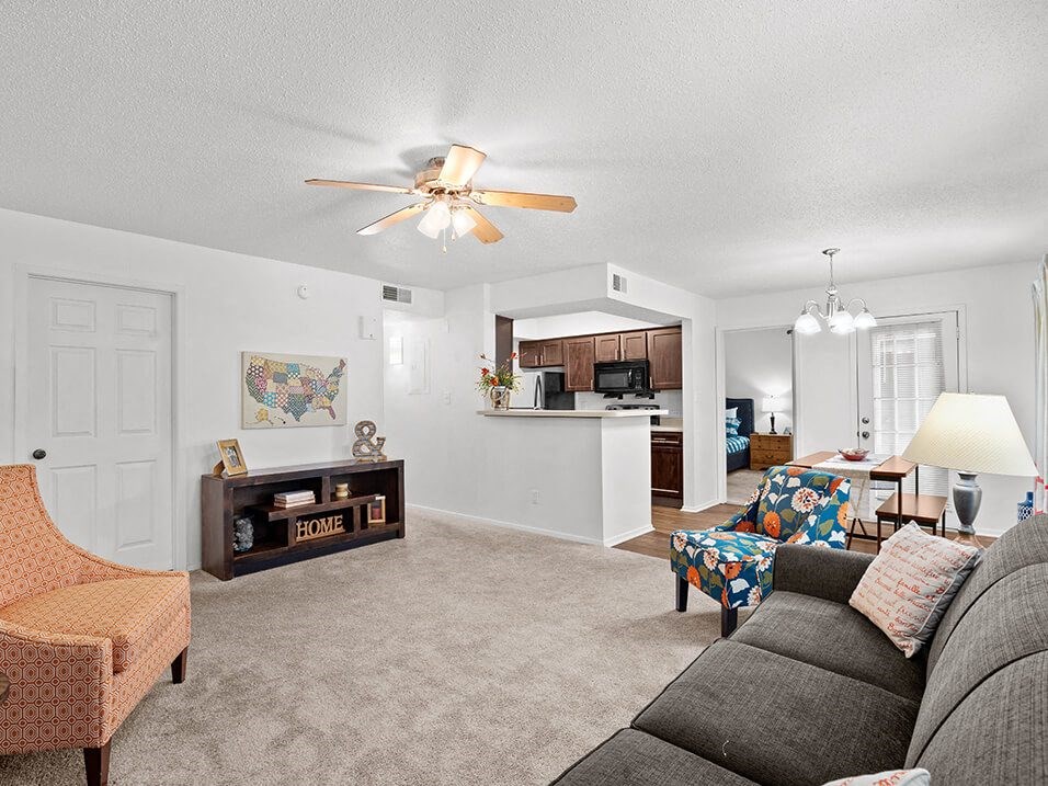 a living room with a couch and a ceiling fan