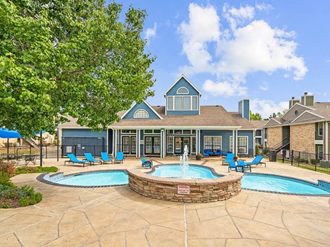 our apartments have a large pool and patio with chairs