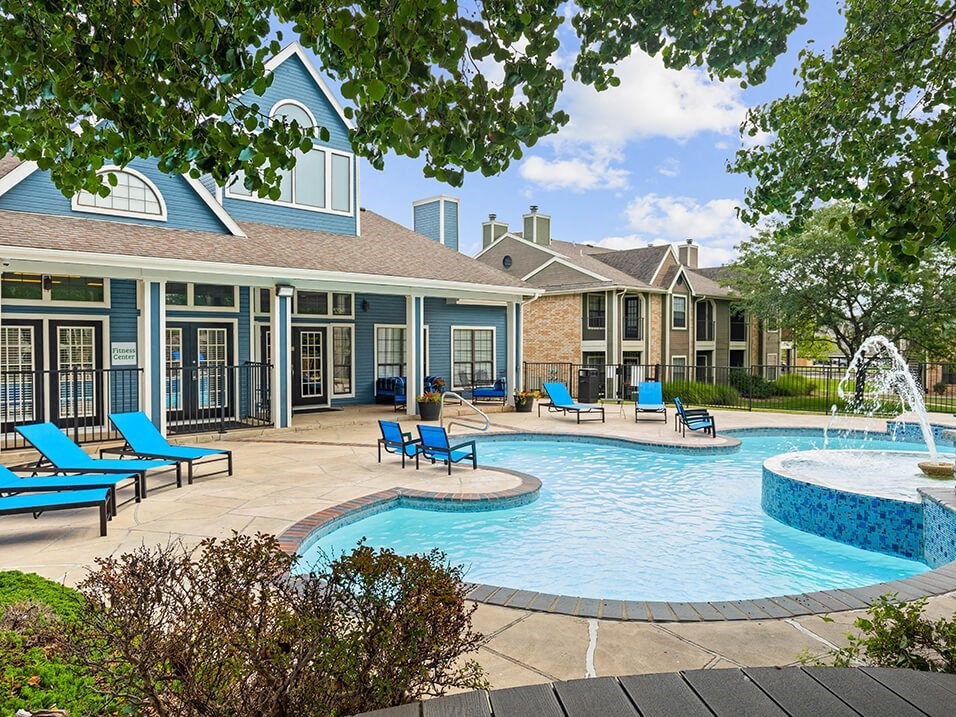 our apartments offer a large pool and patio with chairs