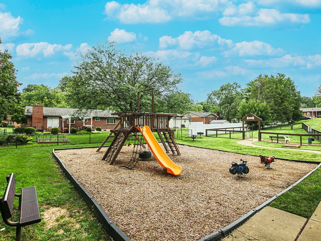 playground with a swing set at apartment