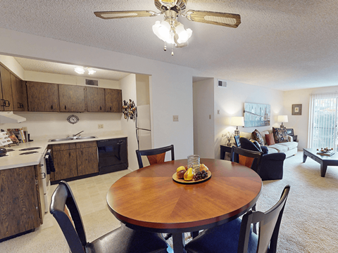 A dining room with a wooden table and chairs.