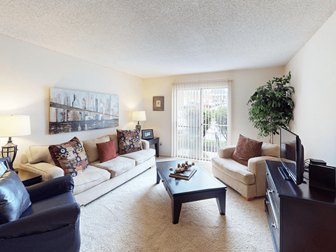 A living room with a couch, chair, and coffee table.
