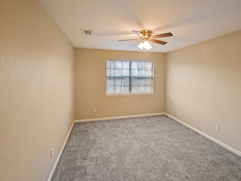 bedroom with a ceiling fan and a window