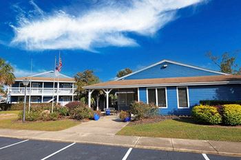 a blue house with an flag and a blue sky