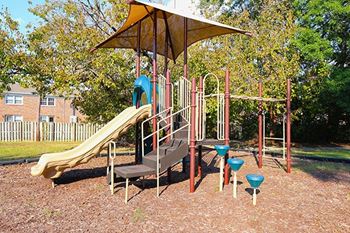 a playground with a slide and other playground equipment