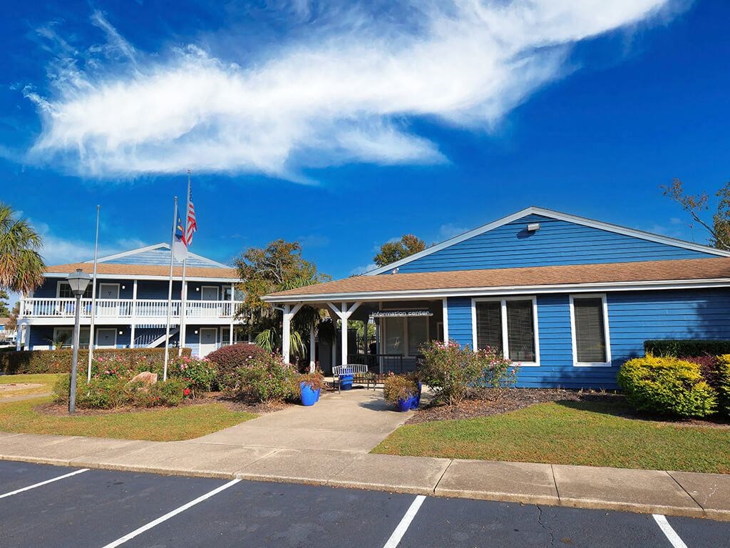 a blue building with a flag and a blue sky