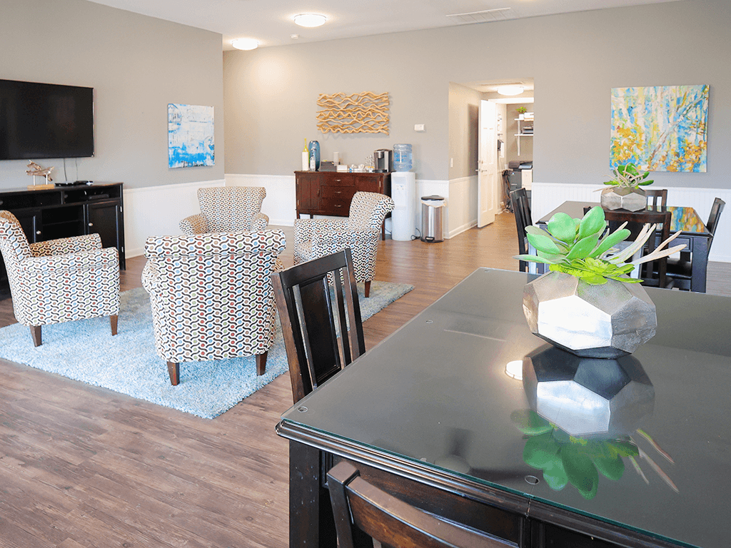 a dining room and living room with a table and chairs