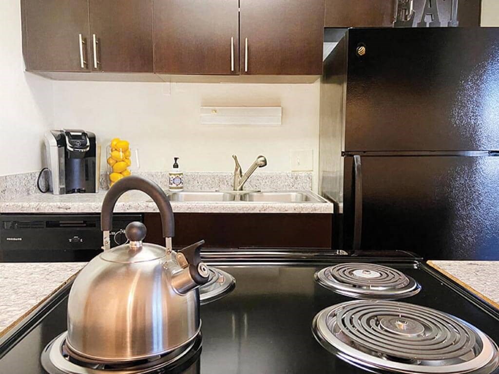 a kitchen with a stove and a kettle on the stove