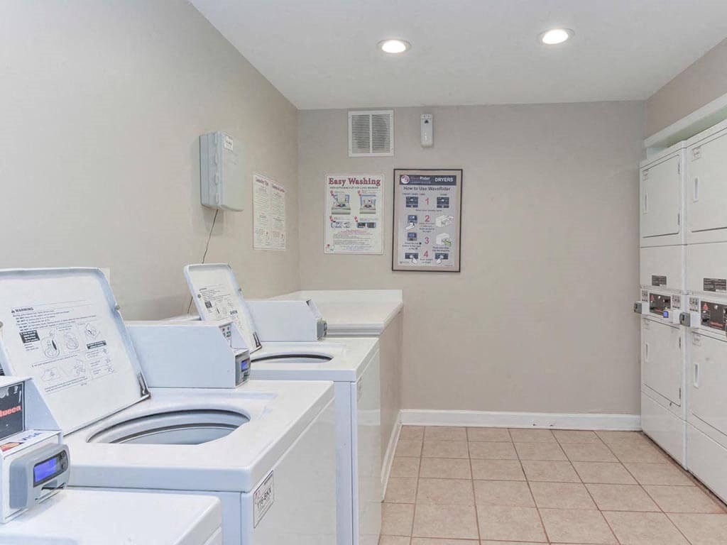 a laundry room with four washes and a dryer