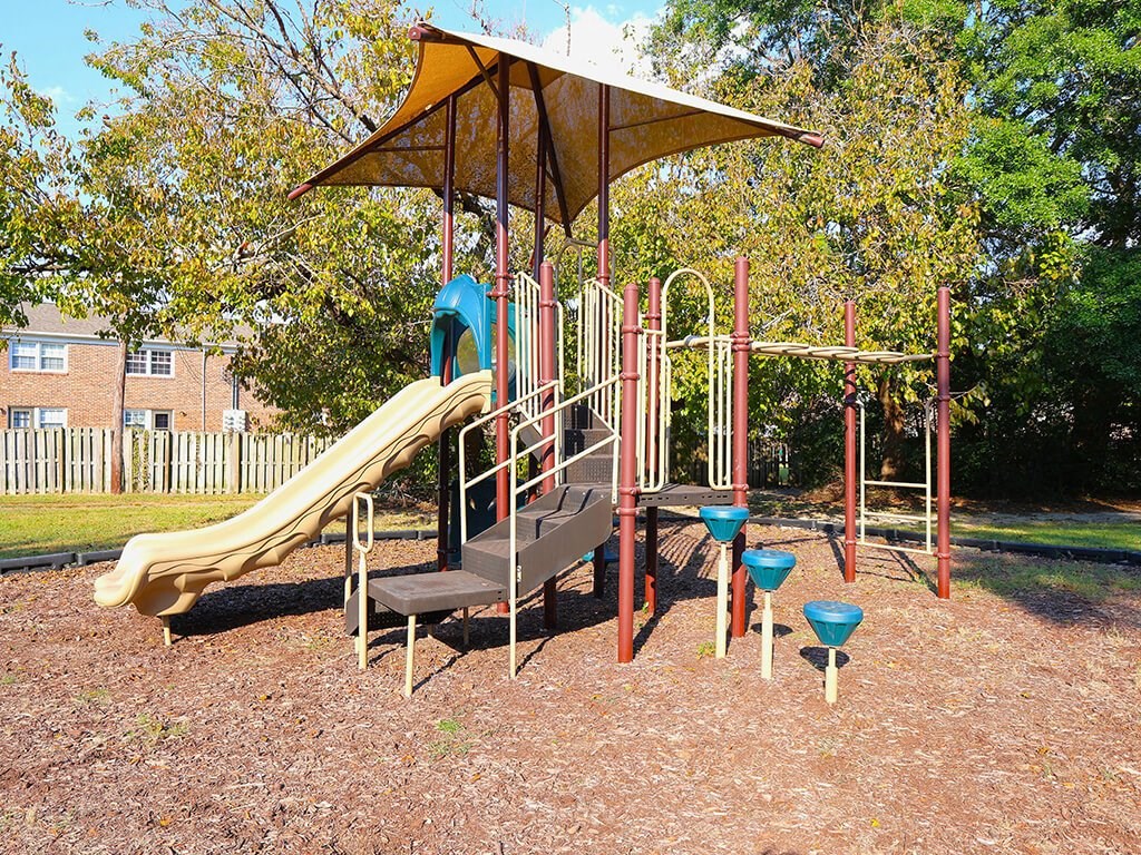 a playground with a slide and other playground equipment