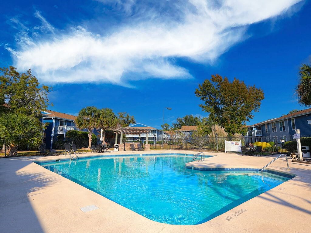 a large swimming pool with a blue sky above it