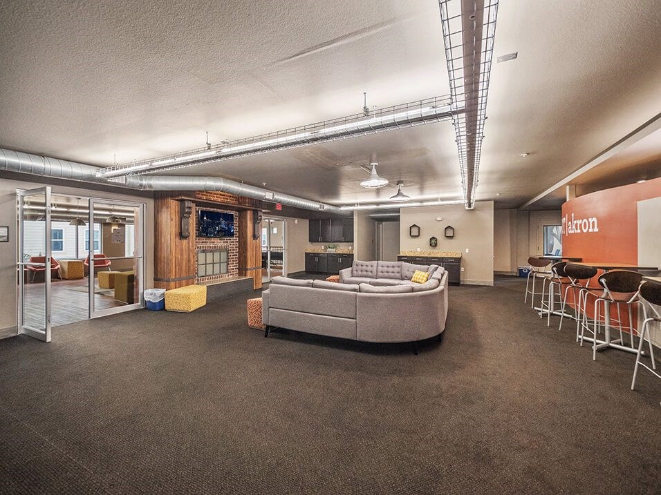 a large living room with a couch and chairs