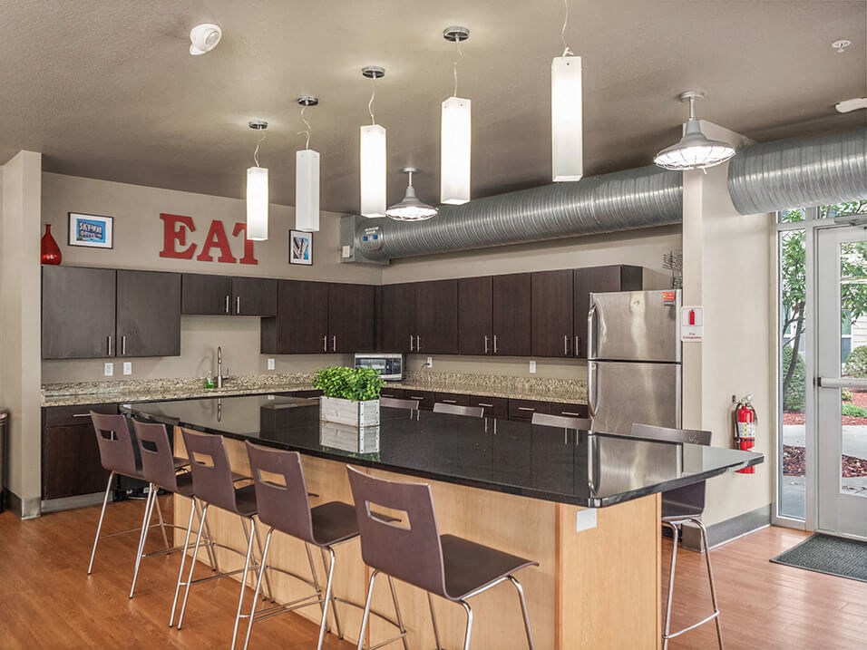 a large kitchen with an island and bar seating