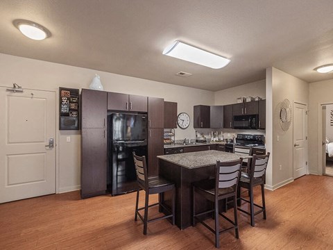 a kitchen with a table and a refrigerator