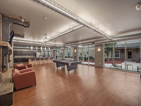 a large room with a pool table and chairs