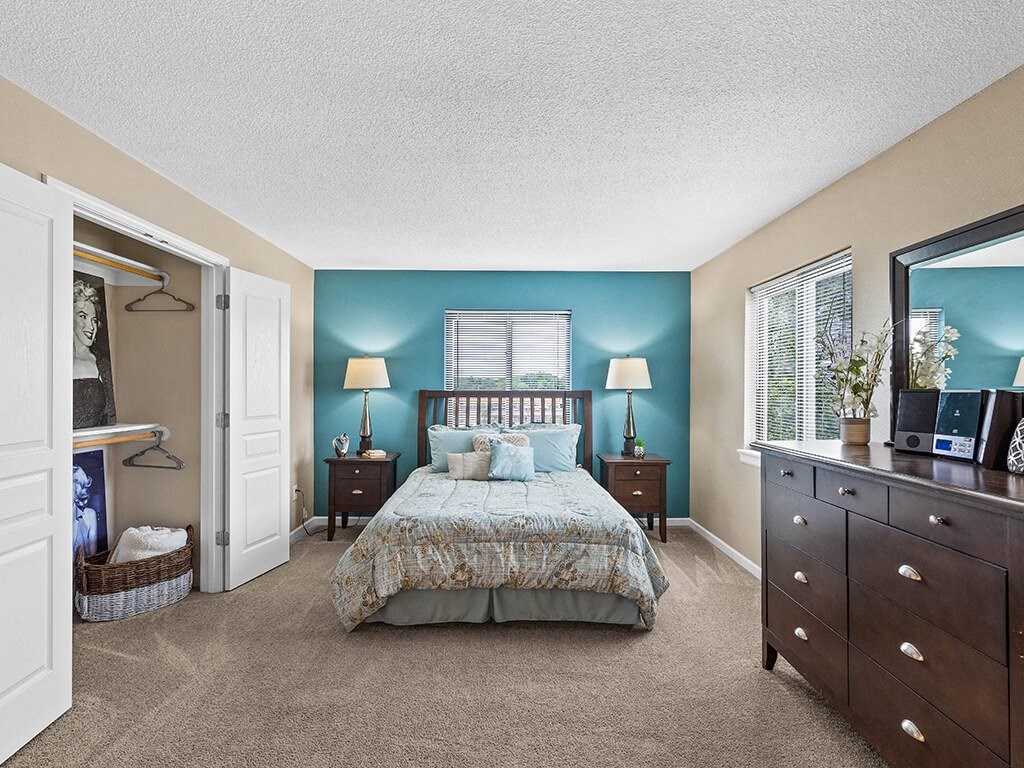 apartment bedroom with a bed and a big closet