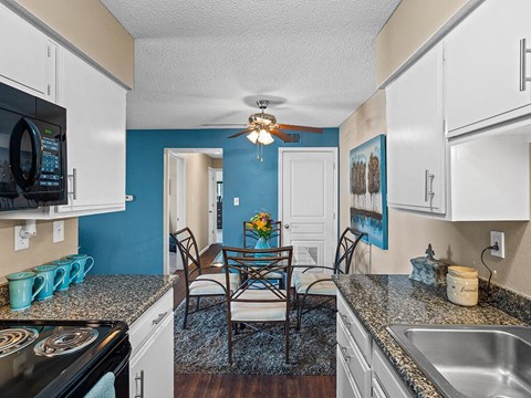 a kitchen and dining room with a table and chairs