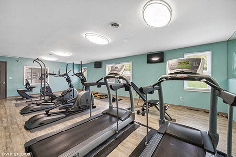 a gym with cardio equipment and exercise machines