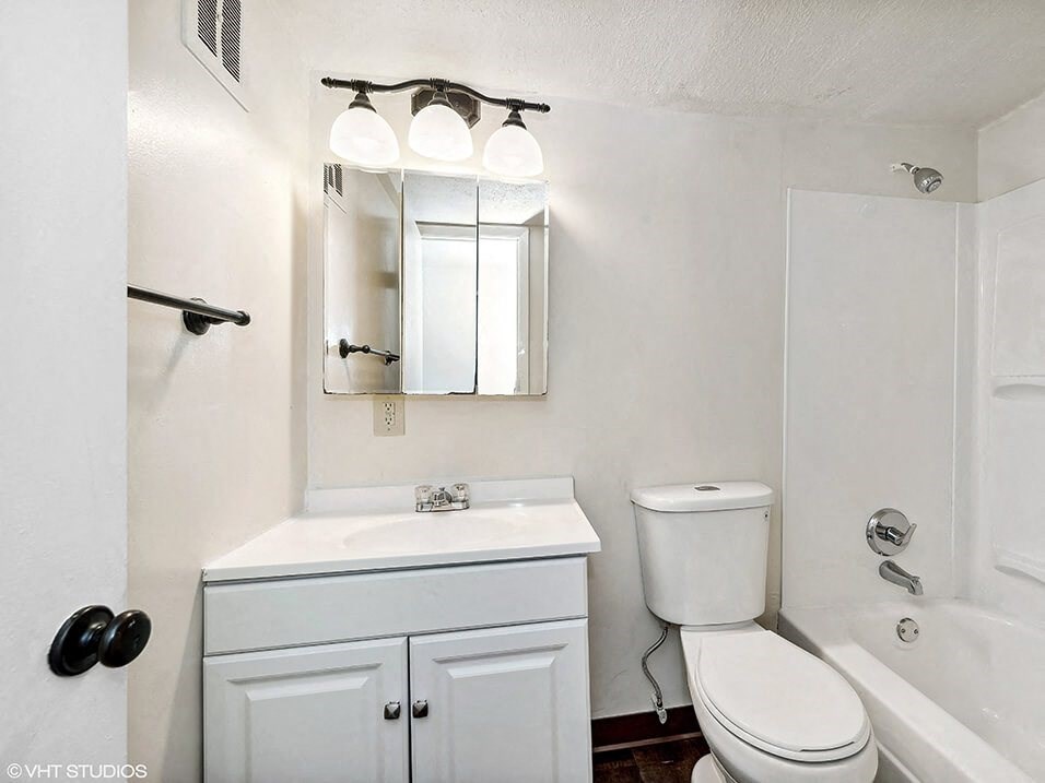a bathroom with a sink toilet and a mirror