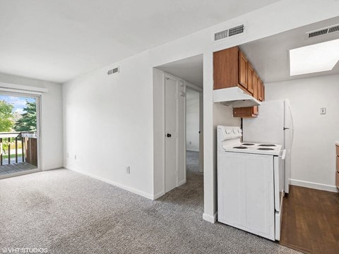 a white kitchen with a white stove and a refrigerator