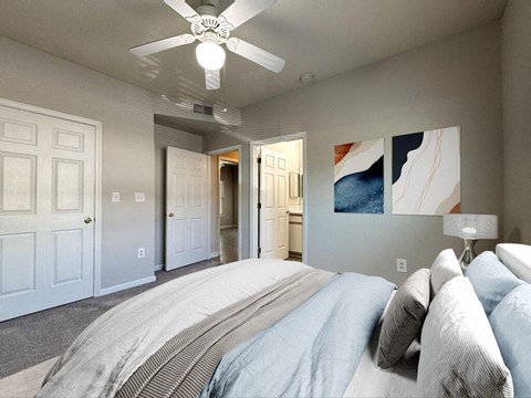 a bedroom with a bed and a ceiling fan