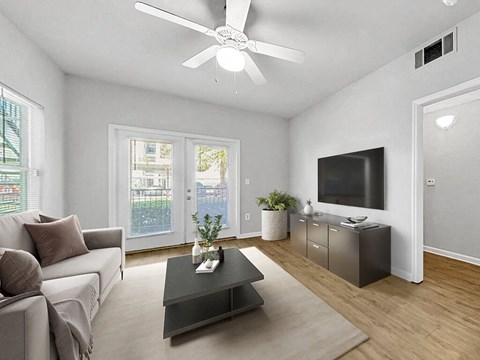 a living room with a couch and a ceiling fan