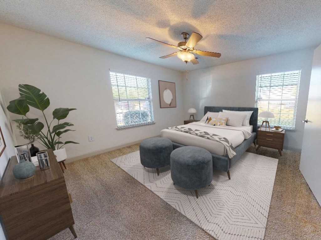a bedroom with a bed and a ceiling fan