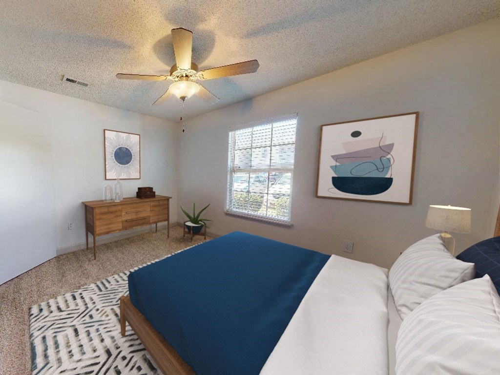 a bedroom with a bed and a ceiling fan