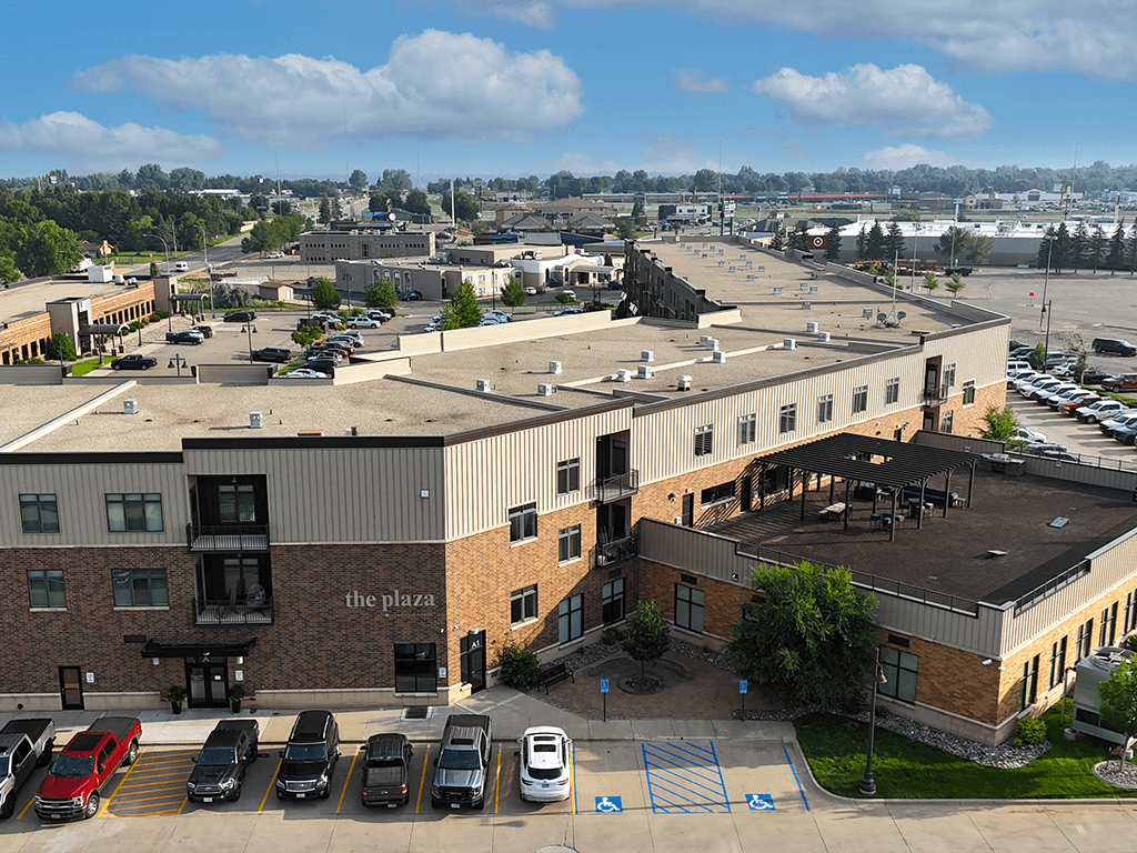 A parking lot with cars and a building named