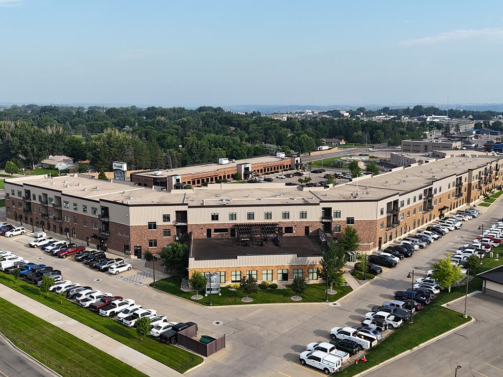 A large building with a parking lot in front of it.