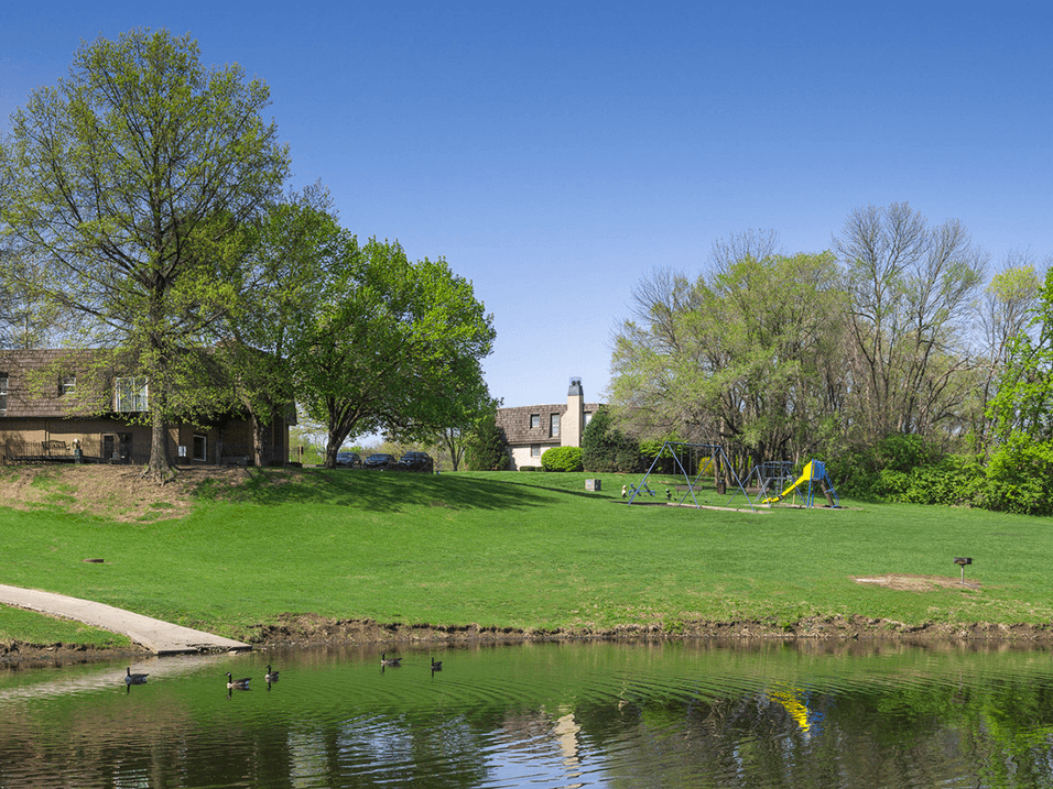 apartment complex with pond