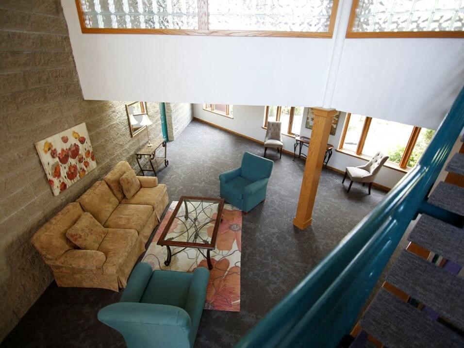 a living room with a couch chairs and a table