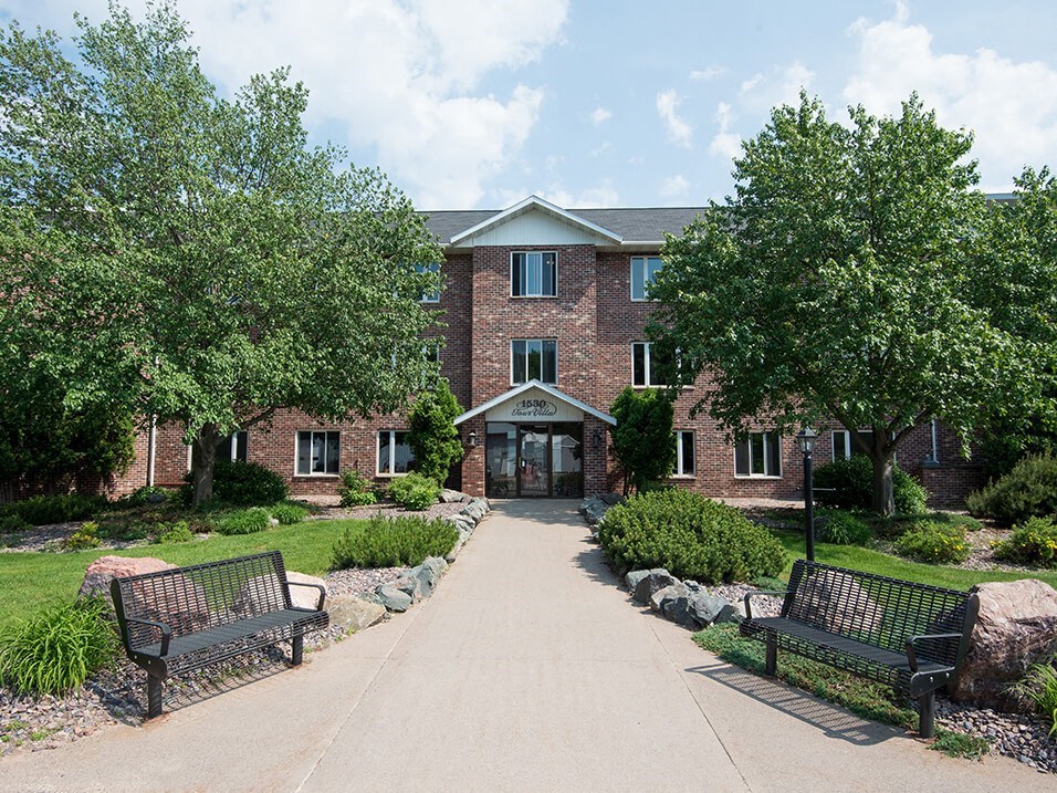 a brick building with two benches in front of it